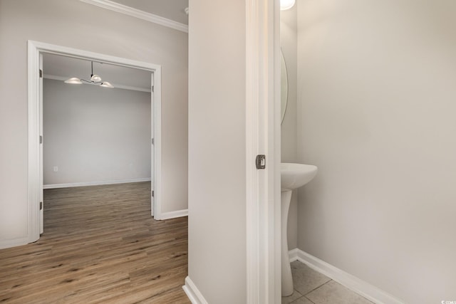 bathroom with crown molding and wood-type flooring