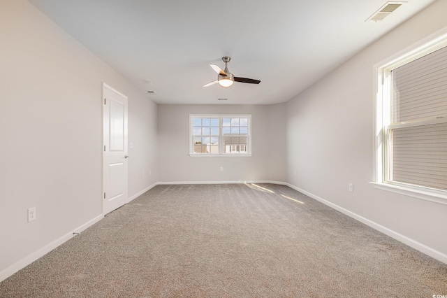 spare room with ceiling fan and carpet