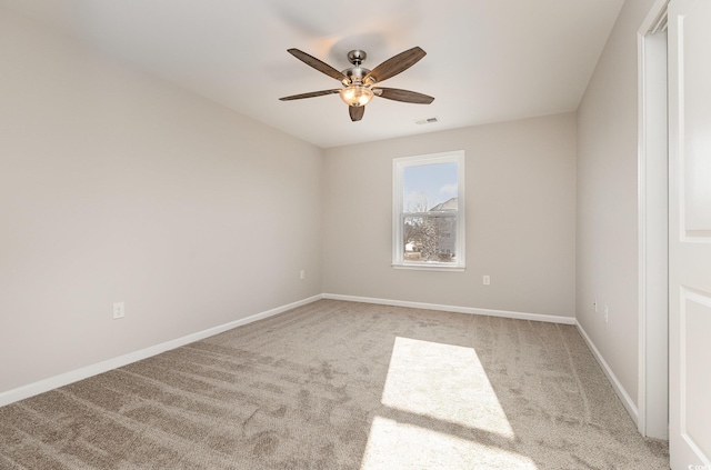 unfurnished room with ceiling fan and light carpet