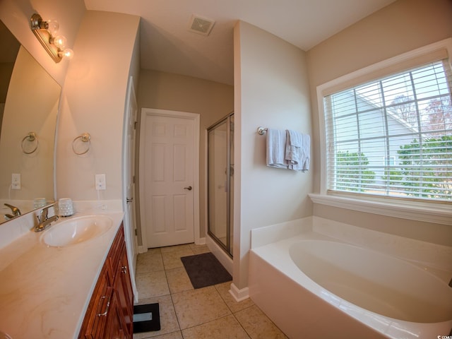 bathroom featuring vanity, tile patterned flooring, and separate shower and tub