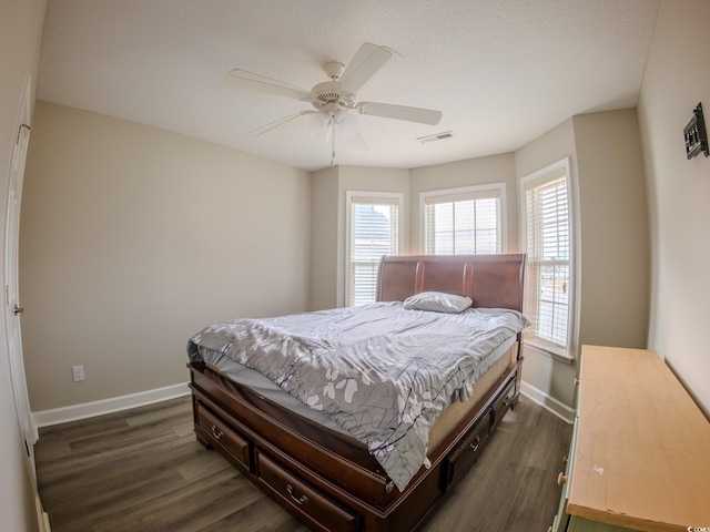 bedroom with dark hardwood / wood-style floors and ceiling fan