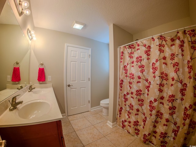 bathroom with a shower with shower curtain, vanity, a textured ceiling, tile patterned floors, and toilet