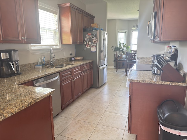788 Rambler Ct, Myrtle Beach, SC 29588 - kitchen with appliances with stainless steel finishes, light tile patterned flooring, light stone counters, and reddish brown cabinets