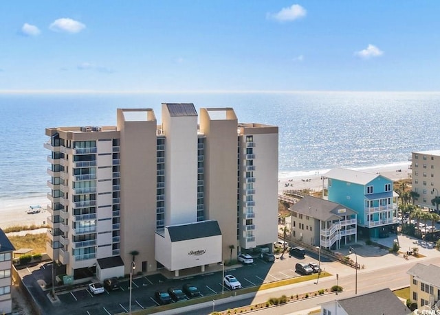 exterior space with a water view and a beach view