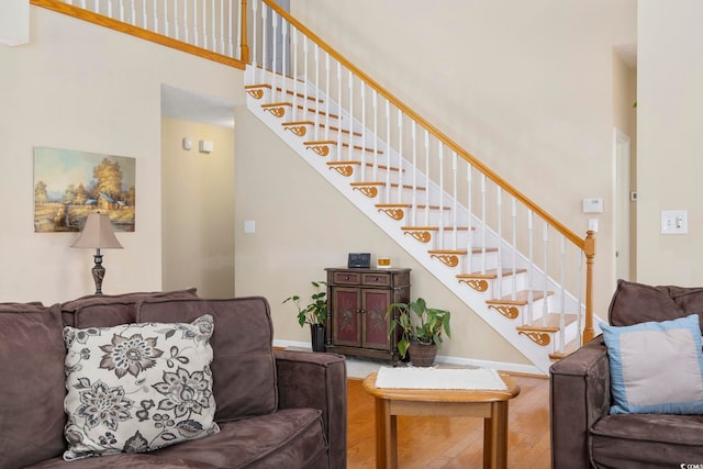 living room featuring hardwood / wood-style floors and a towering ceiling