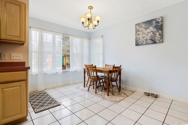 dining area featuring light tile patterned floors and a chandelier