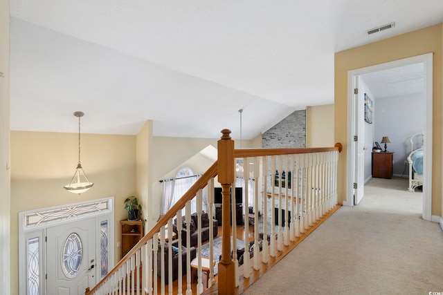 corridor featuring lofted ceiling and light carpet