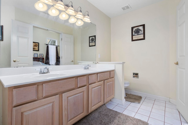 bathroom with vanity, toilet, and tile patterned flooring