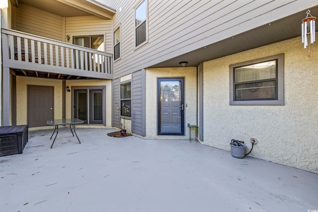 view of exterior entry featuring a patio area