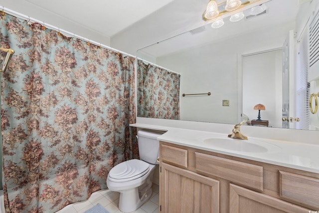 bathroom featuring tile patterned floors, toilet, and vanity