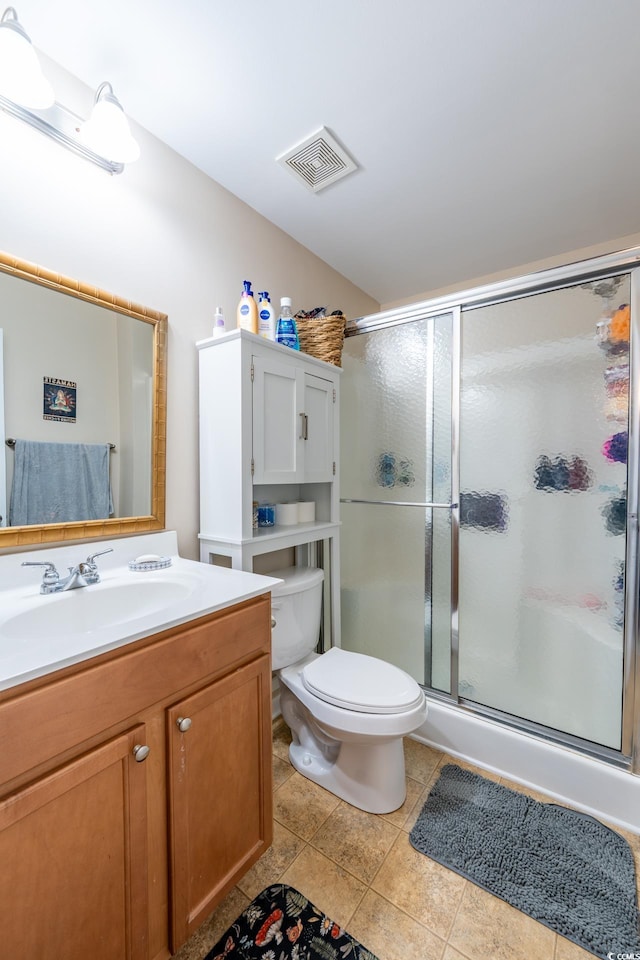 full bathroom featuring tile patterned flooring, toilet, vanity, visible vents, and a stall shower