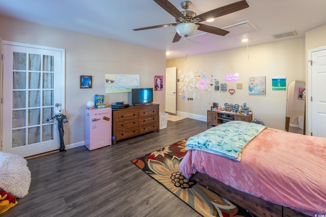 bedroom featuring attic access, visible vents, baseboards, a ceiling fan, and dark wood-style floors