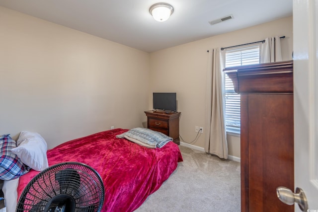 bedroom featuring light carpet, baseboards, and visible vents