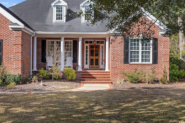 new england style home featuring a front yard