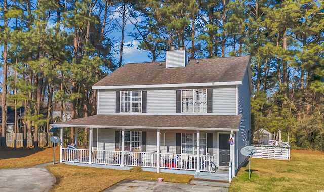 view of front facade with a front yard and covered porch