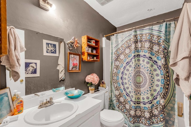 bathroom with vanity, a shower with shower curtain, a textured ceiling, and toilet