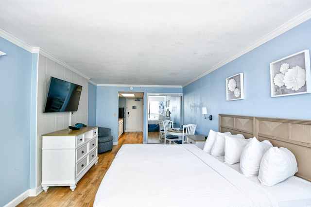 bedroom featuring crown molding and light wood-type flooring