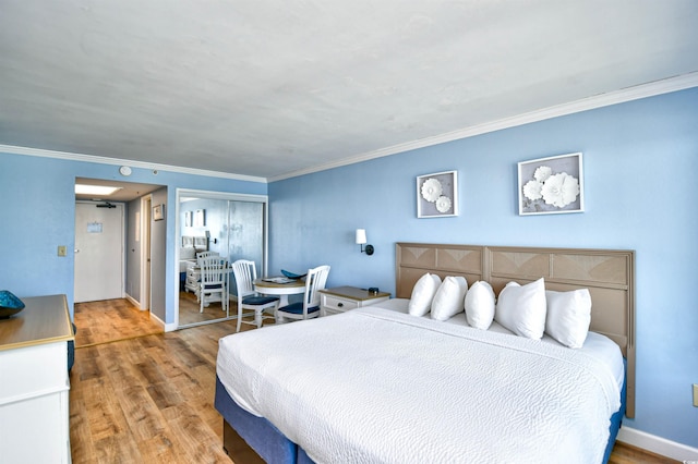 bedroom with crown molding, hardwood / wood-style floors, and a closet