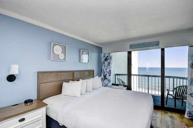 bedroom with hardwood / wood-style flooring, ornamental molding, a water view, and access to exterior