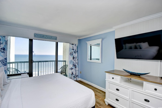 bedroom with access to exterior, ornamental molding, and hardwood / wood-style floors