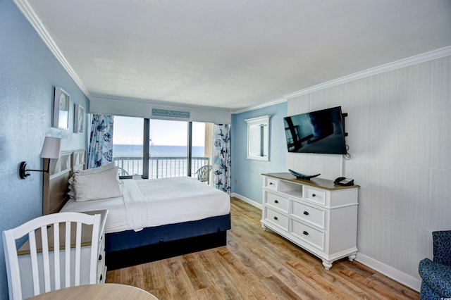 bedroom featuring ornamental molding, light hardwood / wood-style floors, and access to outside