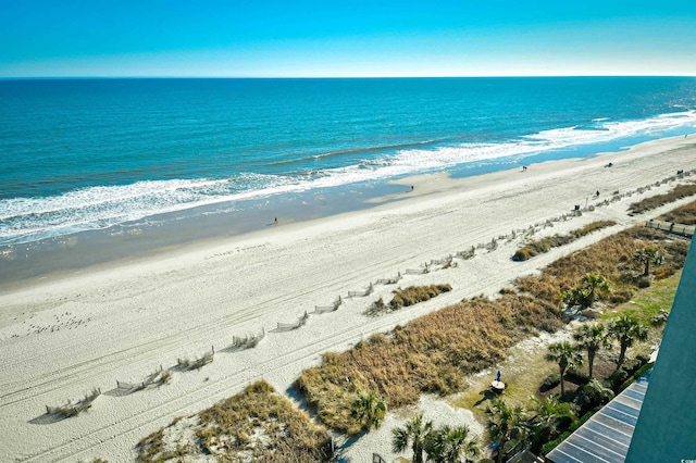 bird's eye view featuring a water view and a beach view