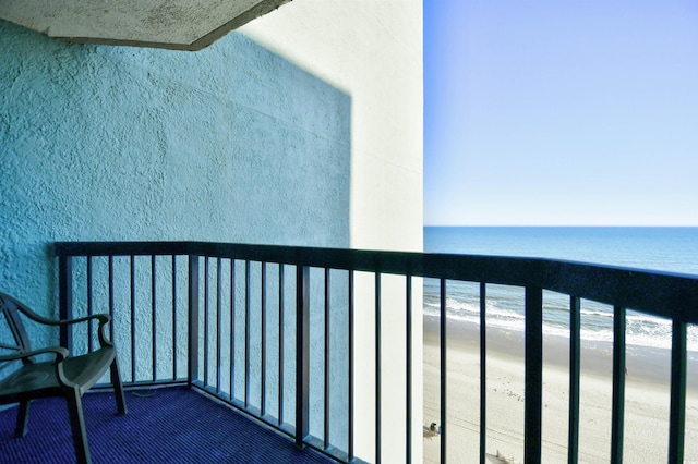 balcony featuring a water view and a view of the beach