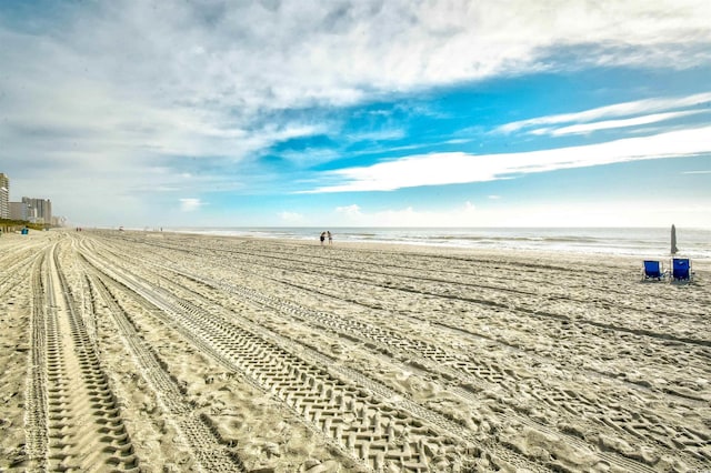 exterior space featuring a beach view and a water view