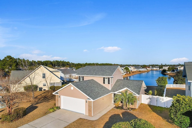 exterior space featuring a garage and a water view