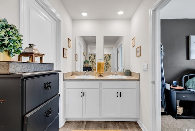 bathroom with vanity and hardwood / wood-style flooring