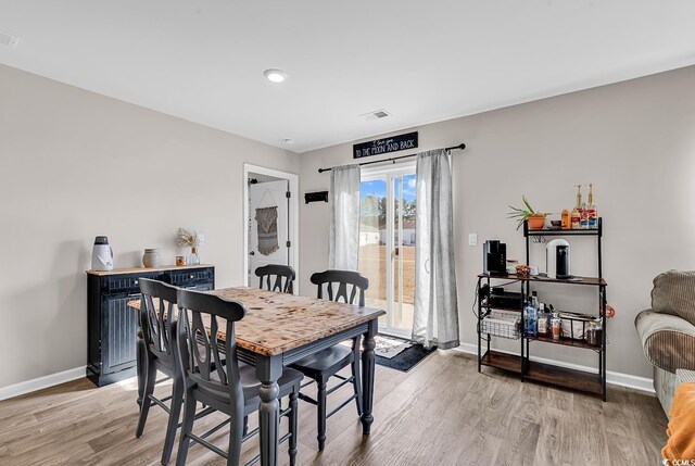 dining area with light wood-type flooring