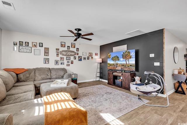 living room with hardwood / wood-style flooring and ceiling fan