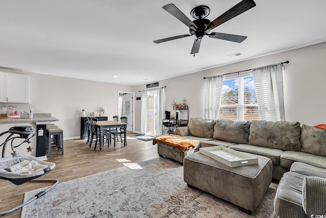 589 Talisman Trl, Longs, SC 29568 - living room with visible vents, light wood-style flooring, ceiling fan, and baseboards