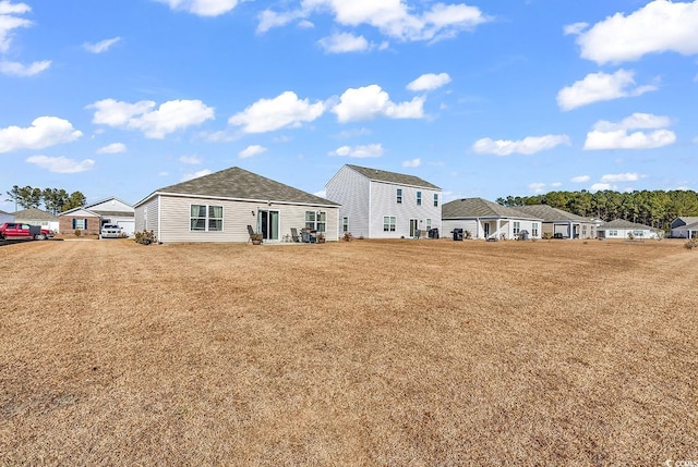 rear view of house with a yard