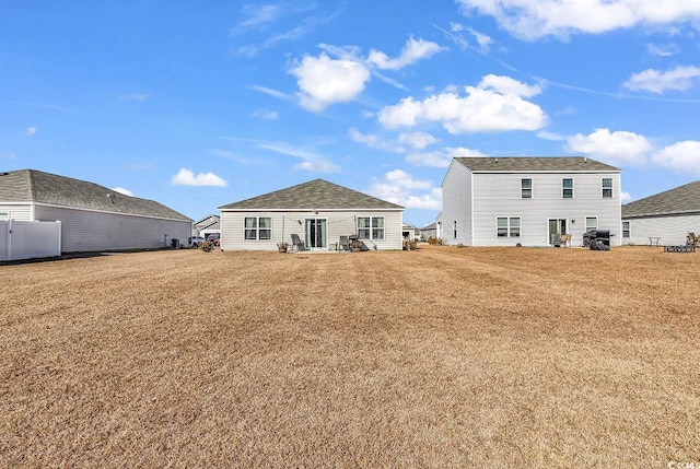 back of house featuring a yard