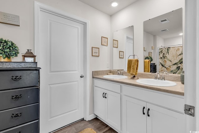 bathroom with a shower with curtain, vanity, and hardwood / wood-style floors