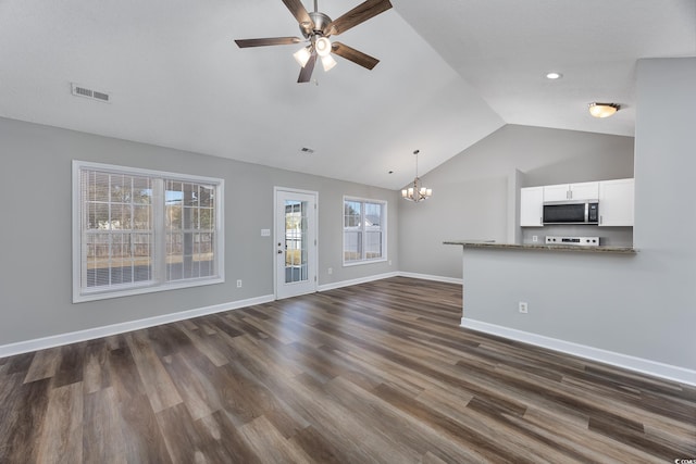 unfurnished living room featuring dark wood-type flooring, lofted ceiling, and ceiling fan with notable chandelier