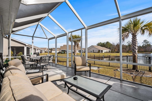 view of patio with a water view, an outdoor living space, and glass enclosure