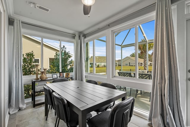 sunroom / solarium featuring ceiling fan