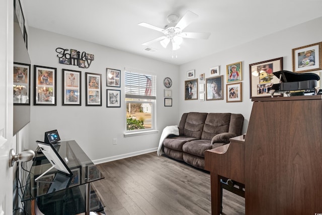 living room featuring hardwood / wood-style floors and ceiling fan