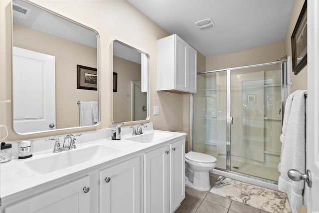 bathroom with tile patterned floors, vanity, toilet, and an enclosed shower