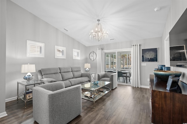 living room featuring lofted ceiling, a notable chandelier, and dark hardwood / wood-style floors