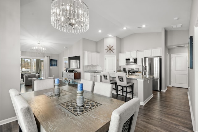 dining area featuring dark hardwood / wood-style flooring, high vaulted ceiling, and a chandelier