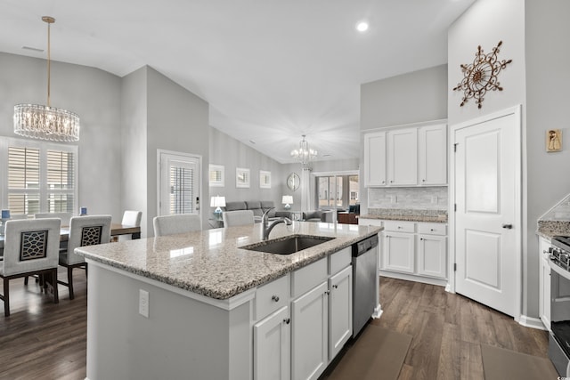 kitchen with sink, decorative light fixtures, dishwasher, a notable chandelier, and a kitchen island with sink