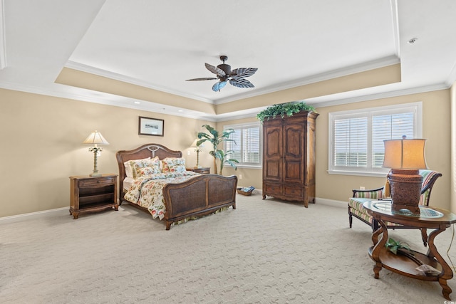 bedroom with a raised ceiling, ceiling fan, light carpet, and crown molding