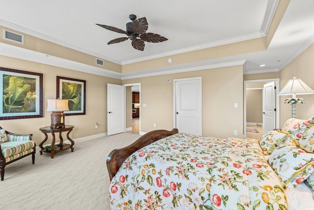 bedroom with ceiling fan, ornamental molding, light carpet, and a tray ceiling