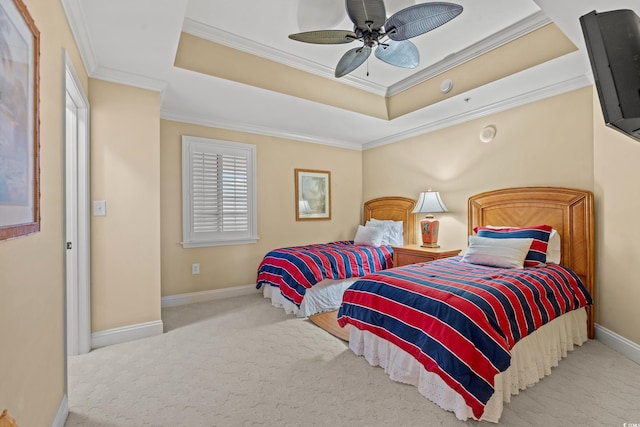 carpeted bedroom featuring a raised ceiling, ceiling fan, and crown molding