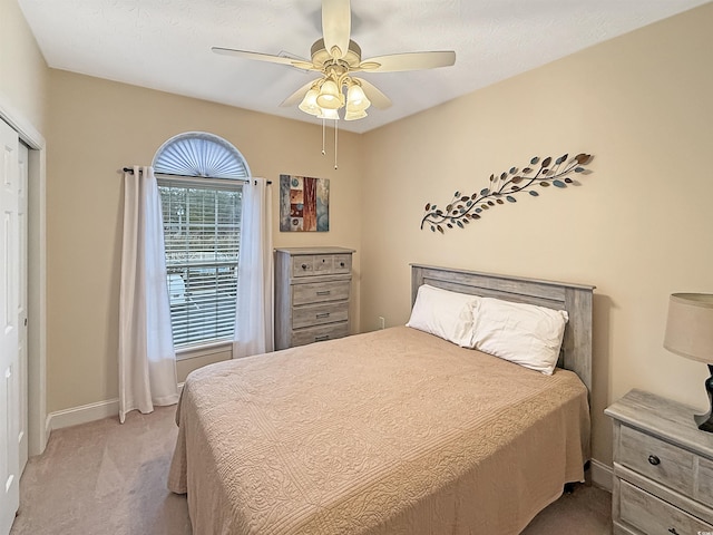 bedroom featuring ceiling fan and light colored carpet