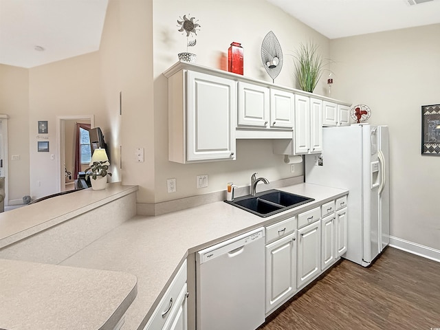 kitchen with sink, white appliances, dark wood-type flooring, and white cabinets