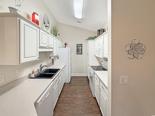 kitchen with visible vents, white appliances, white cabinetry, a sink, and dark wood finished floors